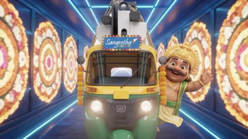 An animated Maveli riding a Sangeetha auto through a neon pookalam tunnel
